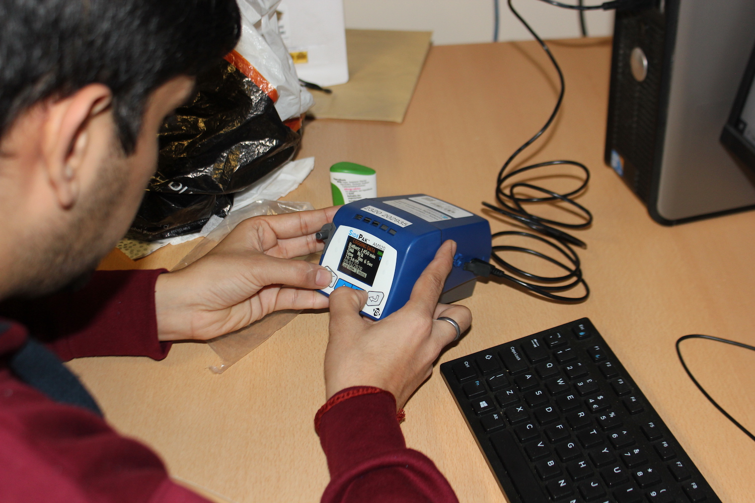 Researcher changing the settings of the Sidepak to configure for the calibration exercise